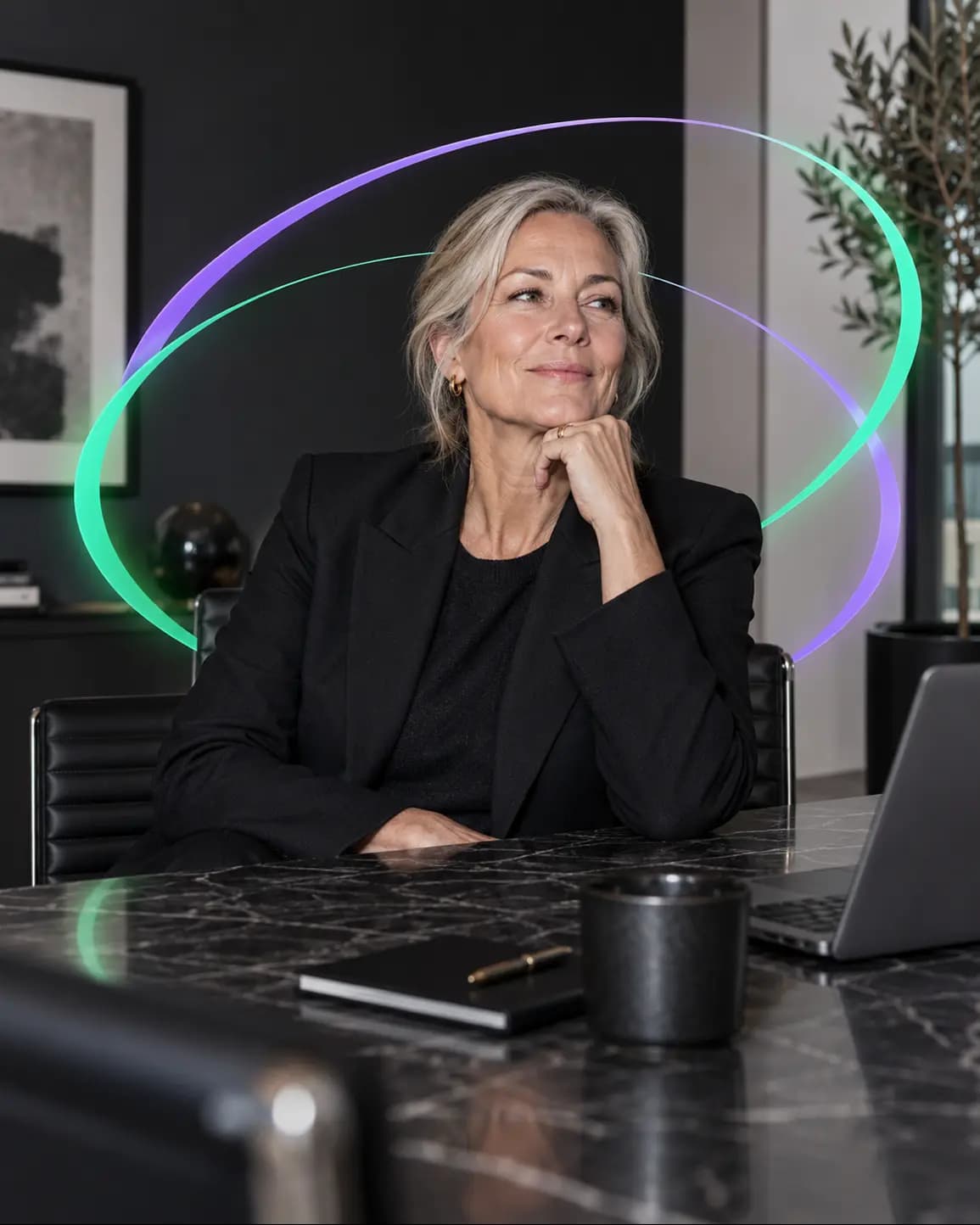 A senior professional sitting at a desk in an office