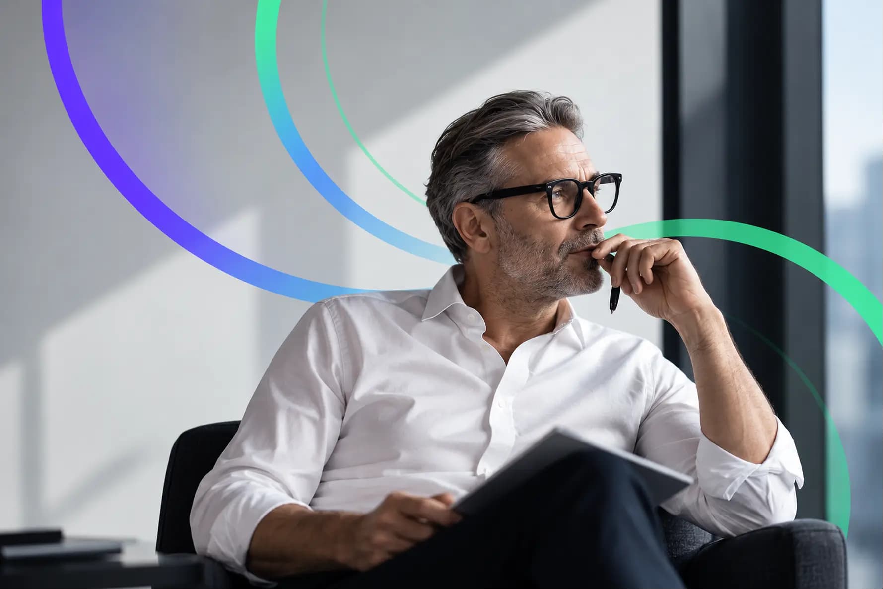A professional reading a document in an office chair